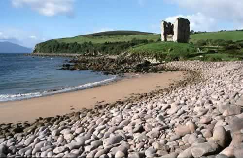 Minard Castle and the rounded stones of Minard Beach on the Dingle Way.